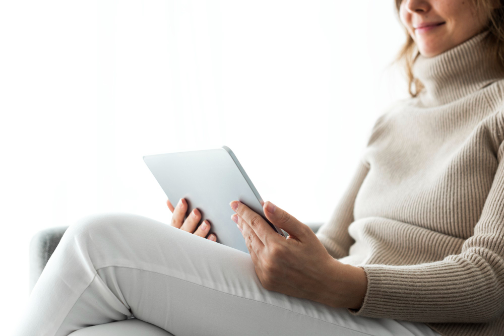 Woman using a tablet on the couch
